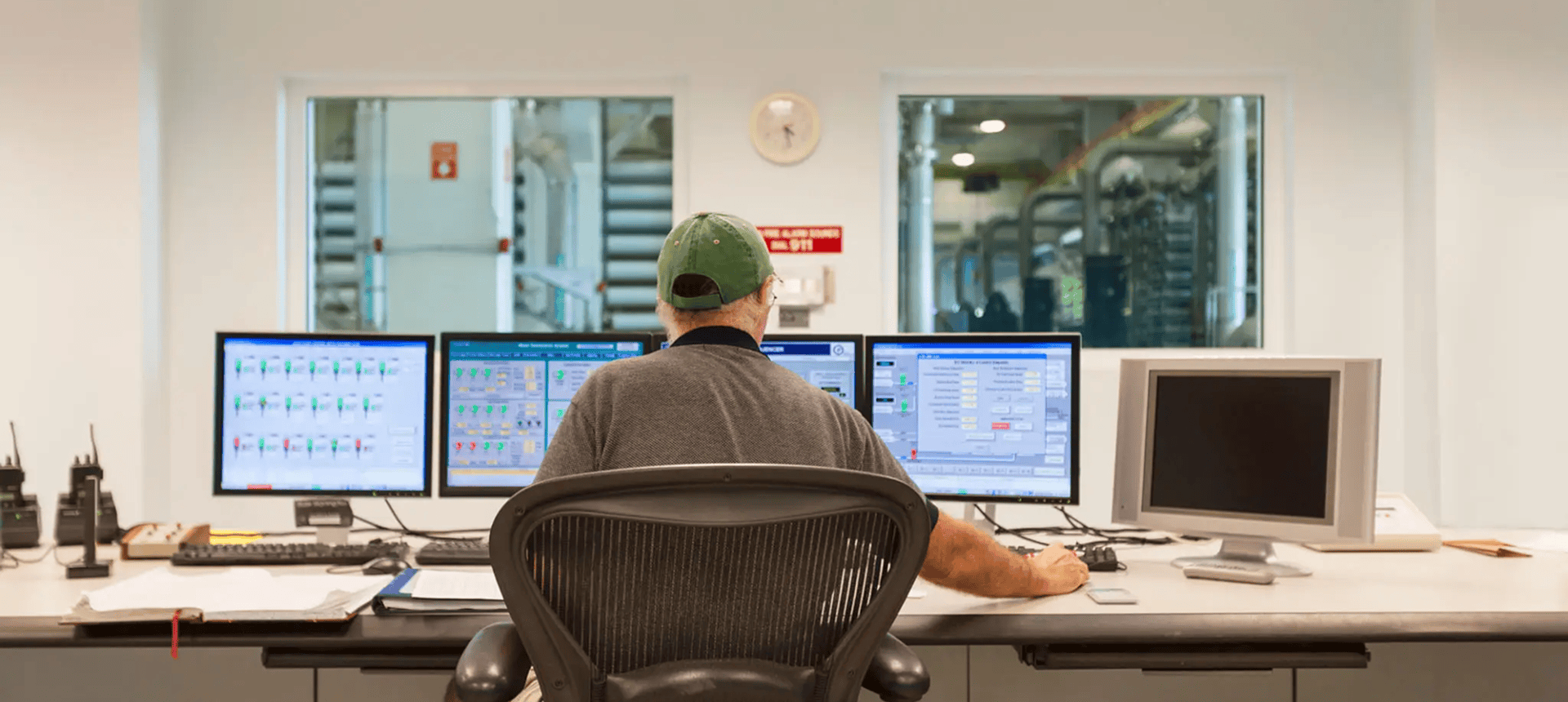 Control room operator monitoring multiple computer screens
